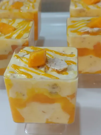This is my version of a Mango Eton Mess. It's a delightful mix of textures with layers of mango puree, creamy custard, chia seeds, and crunchy meringue pieces, all topped with fresh mango cubes.