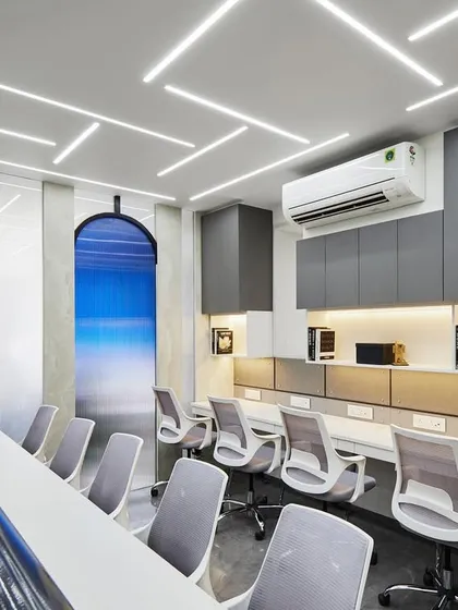 This long workstation is designed for collaboration. Ergonomic chairs provide comfort, while the arched feature wall with a serene blue gradient adds a unique visual element that breaks the monotony of a typical office.