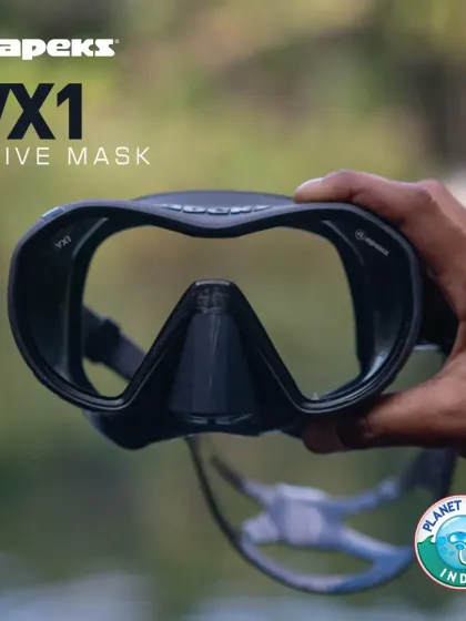 The Apeks VX1 mask, held to showcase its premium, surgical-grade silicone skirt and frameless design. Produced in Italy, this mask is a testament to quality craftsmanship and superior diving comfort.
