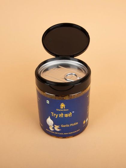 A jar of Garlic Pickle with the lid open, showing the sealed top.