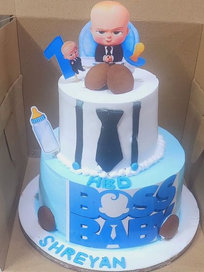 A Boss Baby cake ready for delivery. This two-tier design was made with two different flavors, funfetti and black forest, to cater to different tastes at the party.