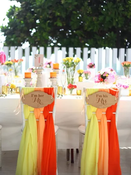 A playful touch for the bride and groom's chairs at a daytime wedding event. It’s these small, personal details that make a celebration uniquely yours.