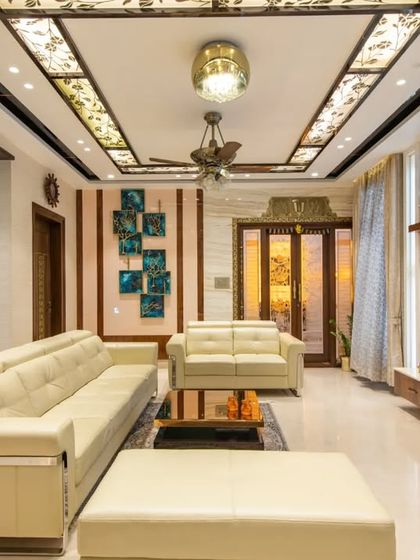 The living room of the "Chic Adobe" penthouse in Bangalore, featuring an open layout that connects the living, dining, and foyer areas.