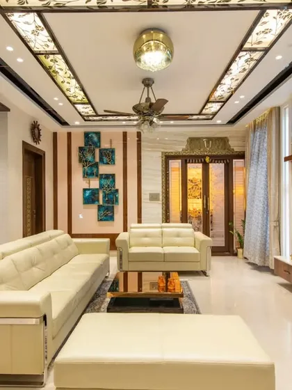The living room of the "Chic Adobe" penthouse in Bangalore, featuring an open layout that connects the living, dining, and foyer areas.