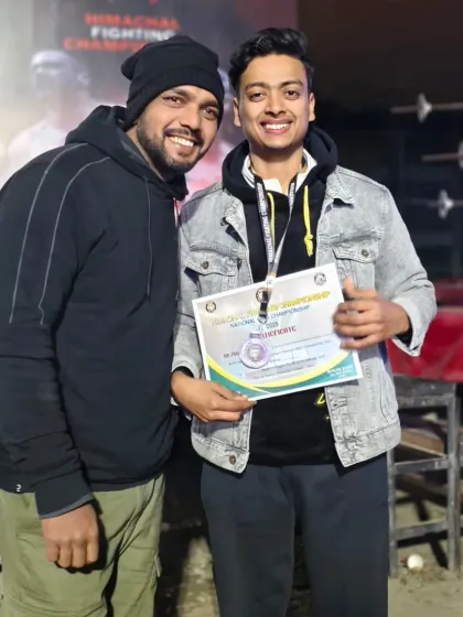 Posing with a student after he received his certificate at a national MMA championship. A proud moment for the team.