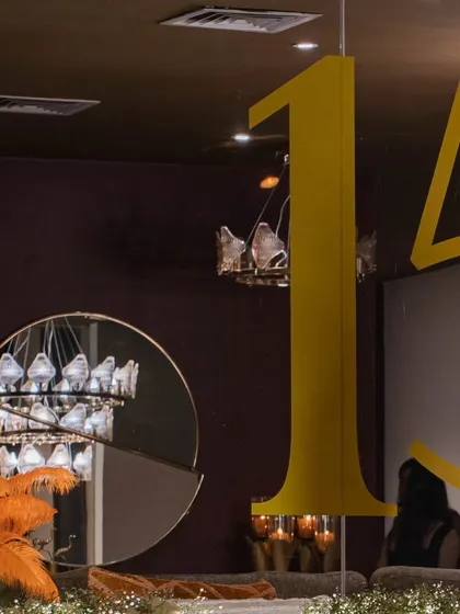 A detail shot showing the large "15" numerals that were part of the anniversary decor, reflecting in a modern mirror. This highlights our use of reflective surfaces and layered design elements.