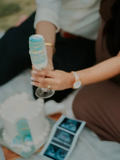 It's a boy. The blue cake revealed in a champagne glass is a creative and celebratory way to announce the baby's gender.