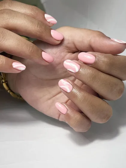The full view of this elegant Russian manicure with swirl art. This design is perfect for clients who want a touch of art without being too flashy.