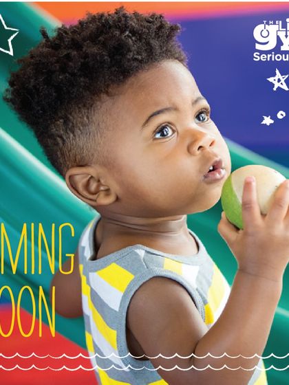 A curious baby explores textures and shapes, holding a small ball. Our classes for the youngest age group are designed to stimulate sensory development and encourage exploration.