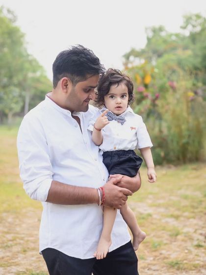 A father and son share a sweet look in this candid outdoor portrait.