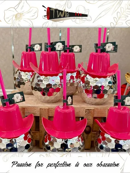 Funky disco ball glasses with pink cowboy hats, a perfect example of our themed glassware.
