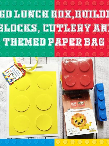 This fun hamper combines a LEGO-style lunch box, a small building block kit, and cutlery, all packed in a handmade block-themed paper bag.