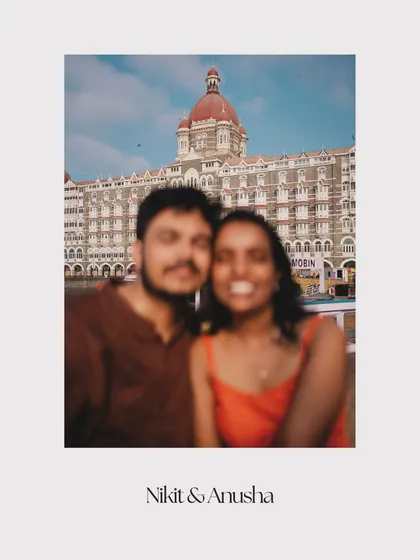 A creative, blurry polaroid-style shot of Nikit and Anusha, with the iconic Taj Mahal Palace Hotel in the background. This photo has a nostalgic, personal, and artistic feel.