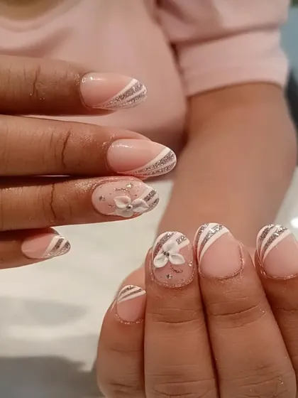 A delicate and pretty design with silver glitter stripes and a small 3D flower on a nude base.