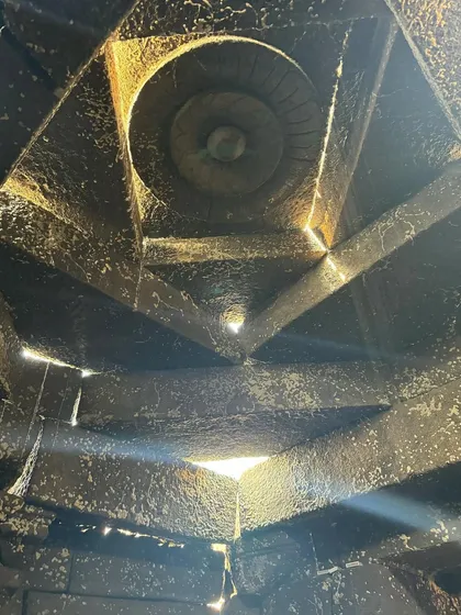The intricate geometry of the temple's ceiling, with small apertures allowing light to enter. This detail shows how ancient construction techniques can be used to create powerful, timeless architectural effects.