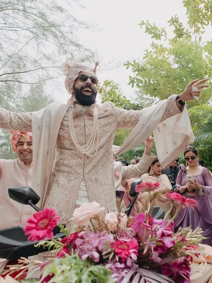 The groom's exuberant entry, full of joy and excitement. We love capturing the groom's personality and the energy of the baraat.