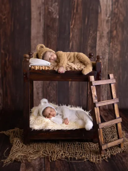 A duplicate of image 28, featuring the artistic portrait of newborn twins in a bunk bed.