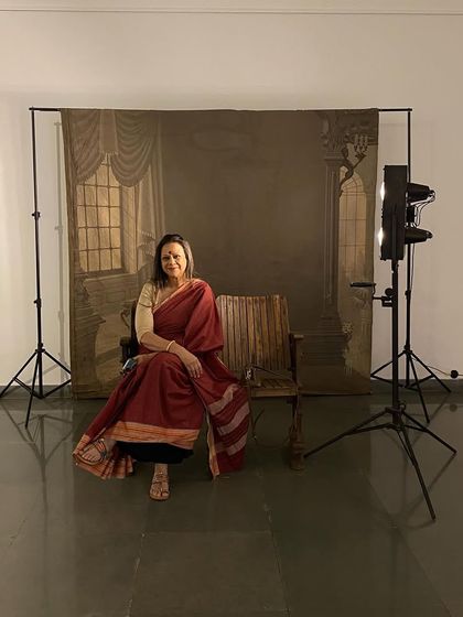 Curator Ina Puri posing for a portrait in the interactive studio setup.