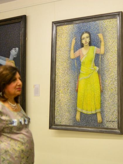 Our founder, Gitanjali Maini, observes a visitor admiring a painting. These moments of quiet connection between the viewer and the art are what we cherish most.
