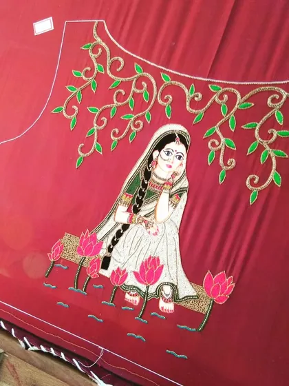 A sneak peek into a concept-based bridal blouse in the making. This piece features a beautiful, hand-embroidered Radha-Krishna inspired painting, perfect for a bride who wants her outfit to tell a unique story.