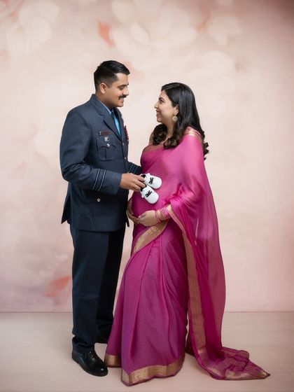 Tiny feet, big dreams. This portrait captures the love and anticipation of a beautiful couple, as the father-to-be from the Indian Air Force holds a pair of baby shoes.