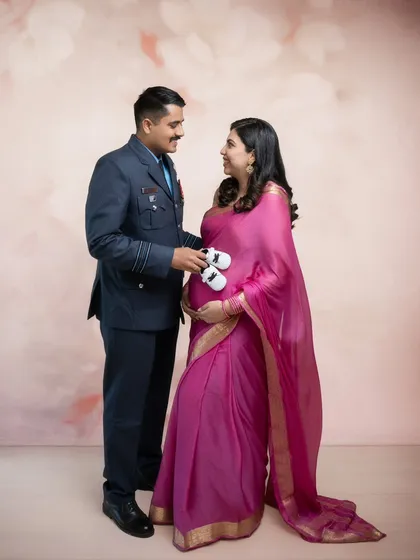 Tiny shoes for tiny feet. This sweet announcement photo combines the pride of his Air Force uniform with the elegance of her saree, creating a portrait that is uniquely their own.