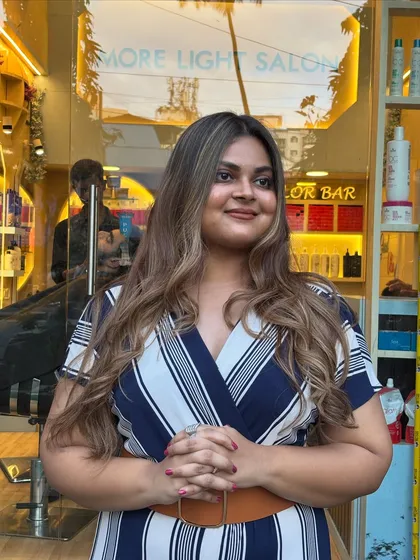 The soft blonde color beautifully complements her skin tone, giving her a warm and inviting look.