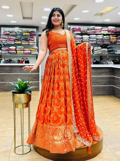 For the fourth day of Navratri, we have this gorgeous orange lehenga. The bandhani print and traditional border honor Goddess Kushmanda in style.