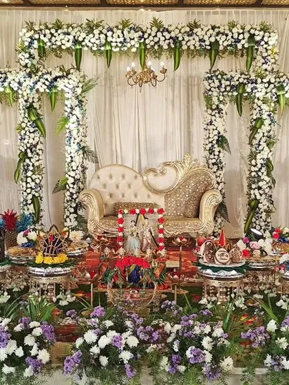 A grand engagement setup with white and blue floral arches, creating a serene and elegant atmosphere.