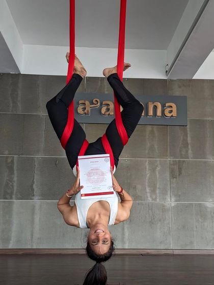 An inverted graduate proudly displays her certificate, a symbol of her dedication and new skills.