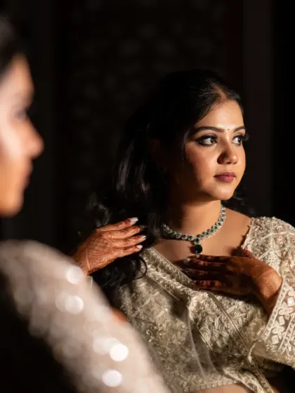 A stunning portrait of the bride-to-be looking at her reflection, captured in a moment of quiet contemplation before her engagement.