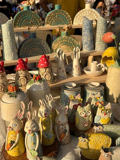 My stall at The Lil Flea, filled with a colorful assortment of my whimsical creations, including Easter bunnies, owl vases, and mushroom houses.