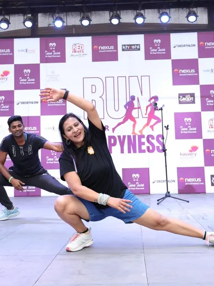 Kicking off a marathon with a dynamic warm-up is crucial for performance and safety. Here, I'm guiding runners through stretches and movements to get their muscles ready and their spirits high for the 'Run for Happiness' event.