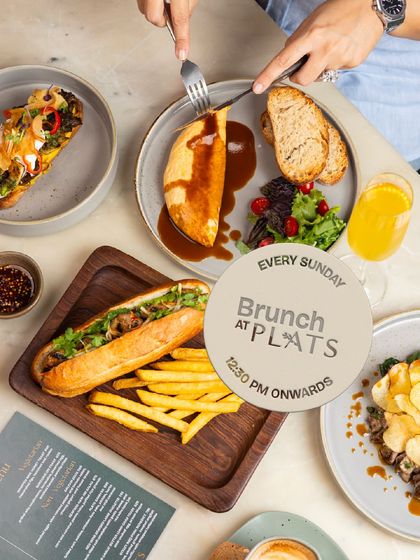 A table laden with some of our brunch favorites, including the Bánh Mì and Braised Lamb Omelette. This is a typical sight on a Sunday at Plats.