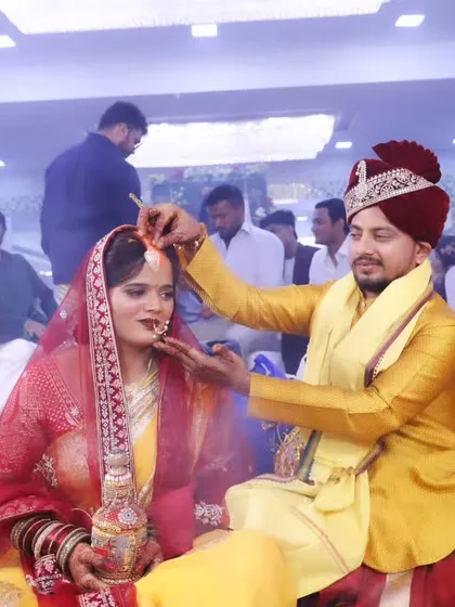 The sacred sindoor moment, a pivotal part of the North Indian wedding ceremony. The bride's makeup remains immaculate throughout.
