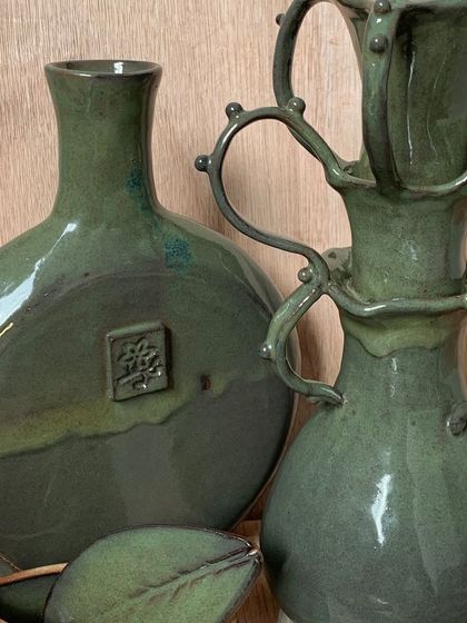 These elegant green-glazed pieces are by Deikim, who stepped out of her comfort zone to explore hand-building and non-functional forms for the showcase.