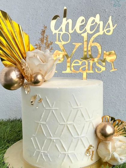 A closer look at our white and gold anniversary cake.