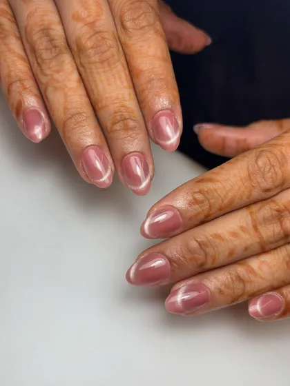 The French cat-eye effect. This design combines the shimmer of a magnetic cat-eye polish with the clean line of a French tip for a subtle yet mesmerizing look.