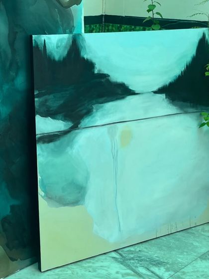 The smaller abstract landscape next to one of the giant fluid paintings, showing how the different pieces in the collection are connected by their color palette.