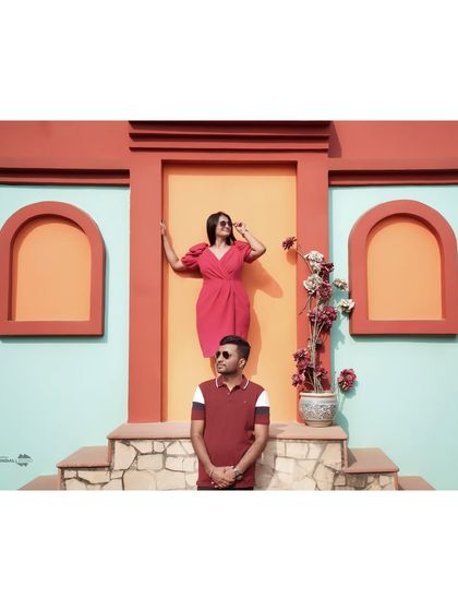 A fun and stylishly composed shot against a colorful, architectural background. This shows how we can use bold colors and creative posing to make your casual shoot pop.