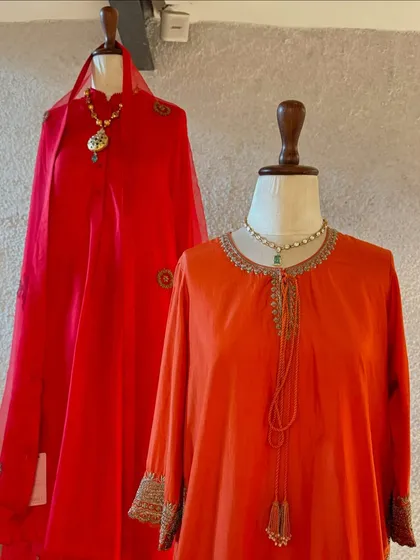 Simple yet stunning. This display features two red kurtas with delicate embroidery, showing that elegance often lies in subtlety.