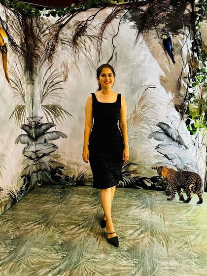 Arpitha posing in her little black dress with a subtle animal print texture, showcasing its versatile style.