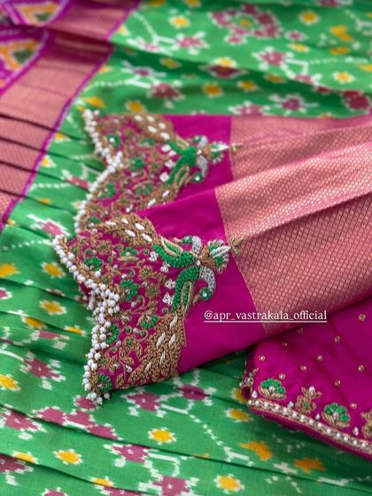 A close-up of the peacock feather embroidery.