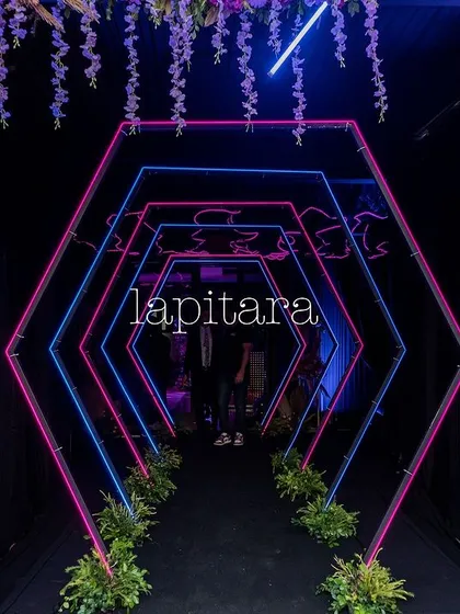 An electrifying entrance for a neon-themed party. This geometric tunnel, lit with vibrant pink and blue neon lights, creates a futuristic and high-energy vibe, guiding guests into the main event space. It demonstrates my ability to execute modern, edgy themes with precision and flair.