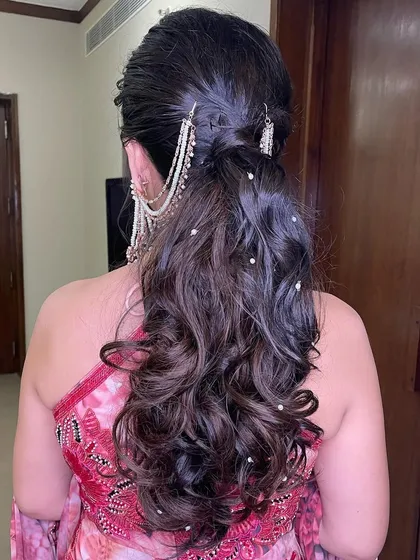 The back view of the pearl-accented ponytail, showing the beautiful cascade of curls.
