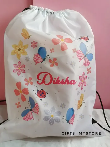 A custom drawstring bag with a cute butterfly and floral print, personalized with her name. Perfect for carrying her essentials.