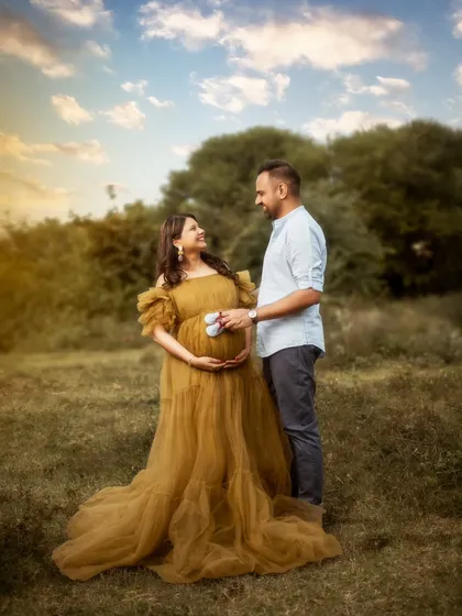 Golden hour magic. The warm light of the setting sun envelops the couple in a beautiful glow. This outdoor maternity portrait is romantic, serene, and utterly breathtaking.