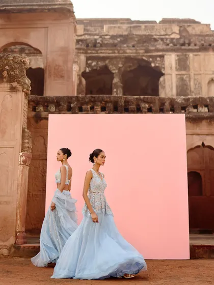 A shot of two models in coordinating powder blue outfits from the Awigna campaign. This shows how to do a cohesive look for the bridal party.