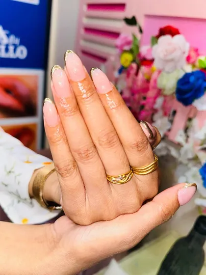 Another view of the chrome French manicure, highlighting the long, graceful almond shape of the extensions.