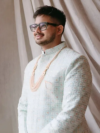 The best man looking sharp in a light blue embroidered sherwani. Our bespoke fits ensure you have the comfort and freedom to celebrate without restriction.